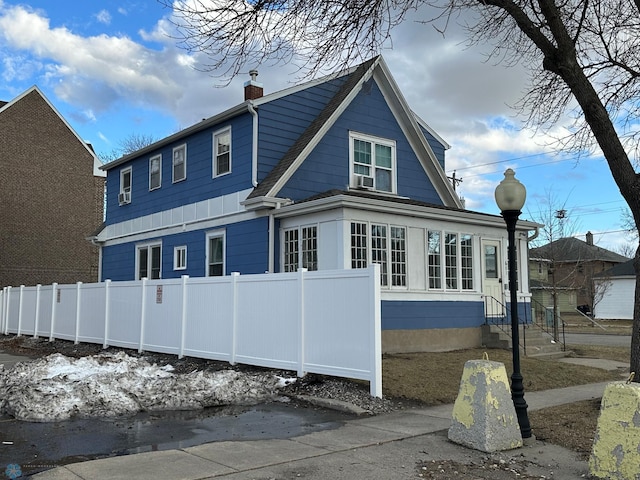 exterior space featuring fence and a chimney