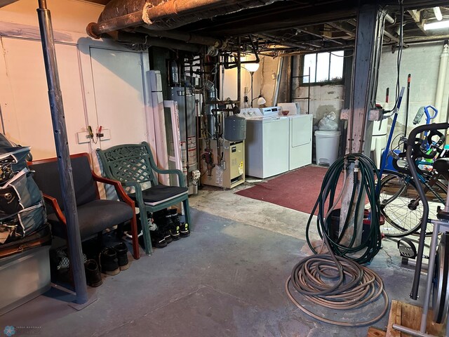 below grade area featuring washing machine and clothes dryer and gas water heater