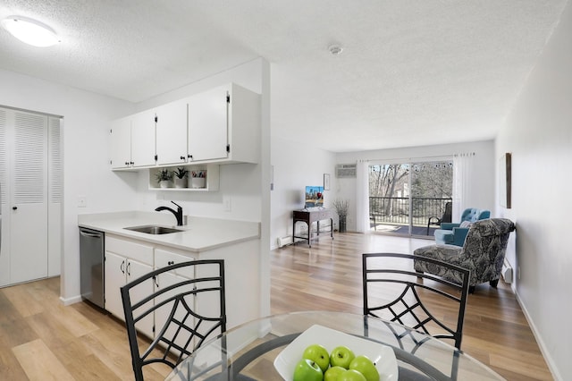 2800 Hillsboro Ave N Unit 220, New Hope, MN 55427 - kitchen with dishwasher, a textured ceiling, light wood-style floors, open floor plan, and light countertops