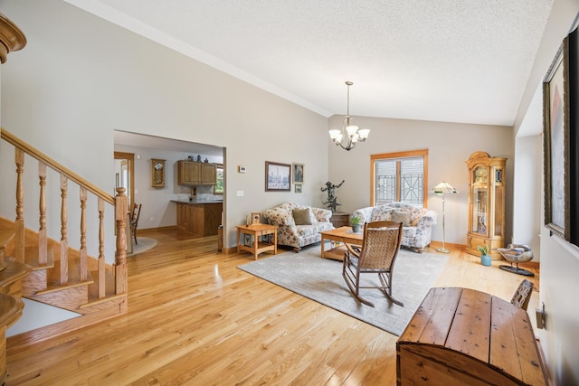 5475 Oakgreen Pl N, Oak Park Heights, MN 55082 - living room with lofted ceiling, light wood-style flooring, stairs, and a chandelier