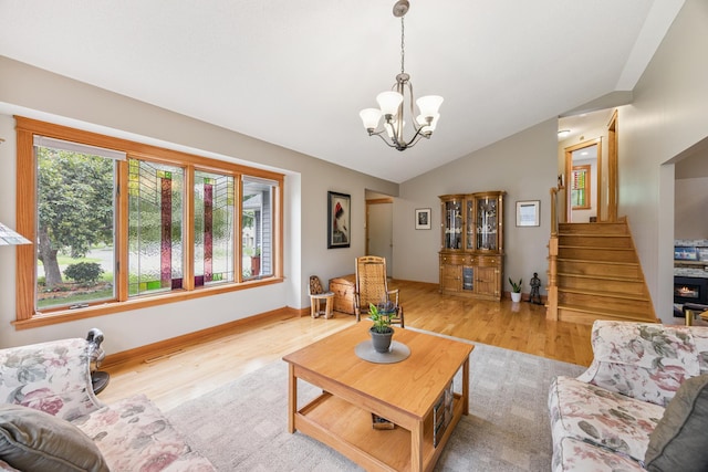 5475 Oakgreen Pl N, Oak Park Heights, MN 55082 - living area with light wood-style flooring, a chandelier, vaulted ceiling, and stairs