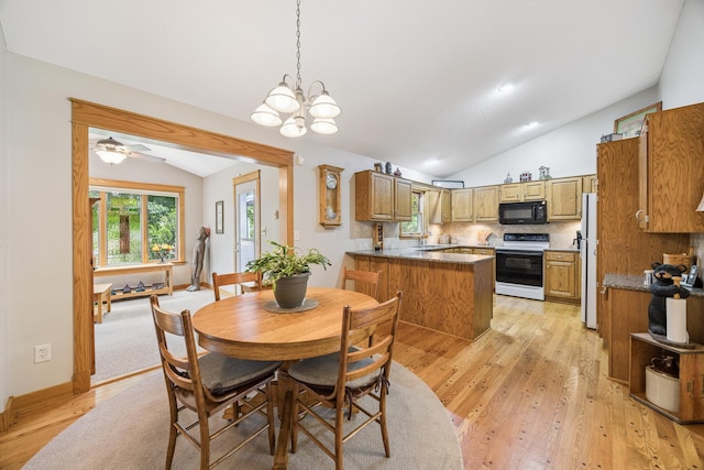 5475 Oakgreen Pl N, Oak Park Heights, MN 55082 - dining area featuring lofted ceiling, light wood-style floors, and a chandelier
