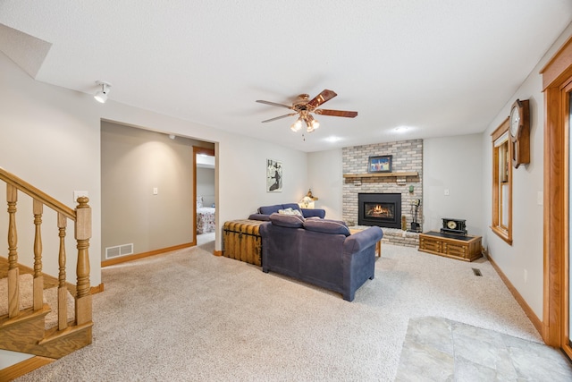5475 Oakgreen Pl N, Oak Park Heights, MN 55082 - carpeted living room with ceiling fan, stairs, and a brick fireplace