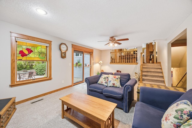 5475 Oakgreen Pl N, Oak Park Heights, MN 55082 - living area with carpet flooring, ceiling fan, stairway, and a textured ceiling