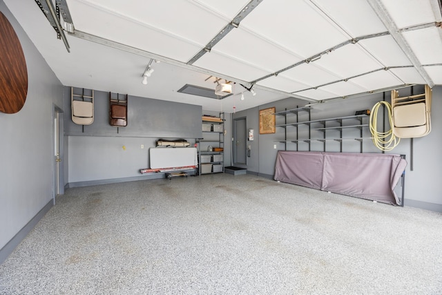5475 Oakgreen Pl N, Oak Park Heights, MN 55082 - garage featuring a garage door opener and baseboards