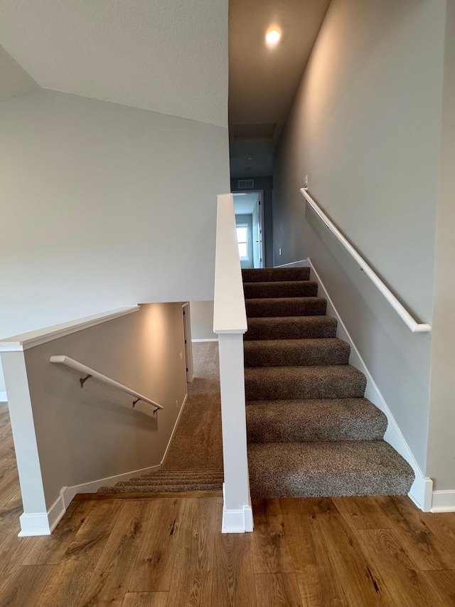 9829 89th St S, Cottage Grove, MN 55016 - staircase featuring wood finished floors, baseboards, and lofted ceiling