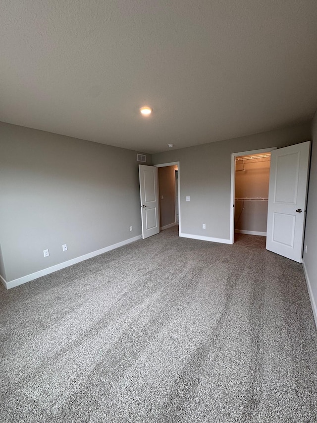 9829 89th St S, Cottage Grove, MN 55016 - unfurnished bedroom featuring baseboards, a walk in closet, carpet flooring, recessed lighting, and a closet