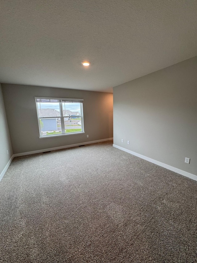 9829 89th St S, Cottage Grove, MN 55016 - carpeted spare room featuring baseboards, a textured ceiling, and recessed lighting