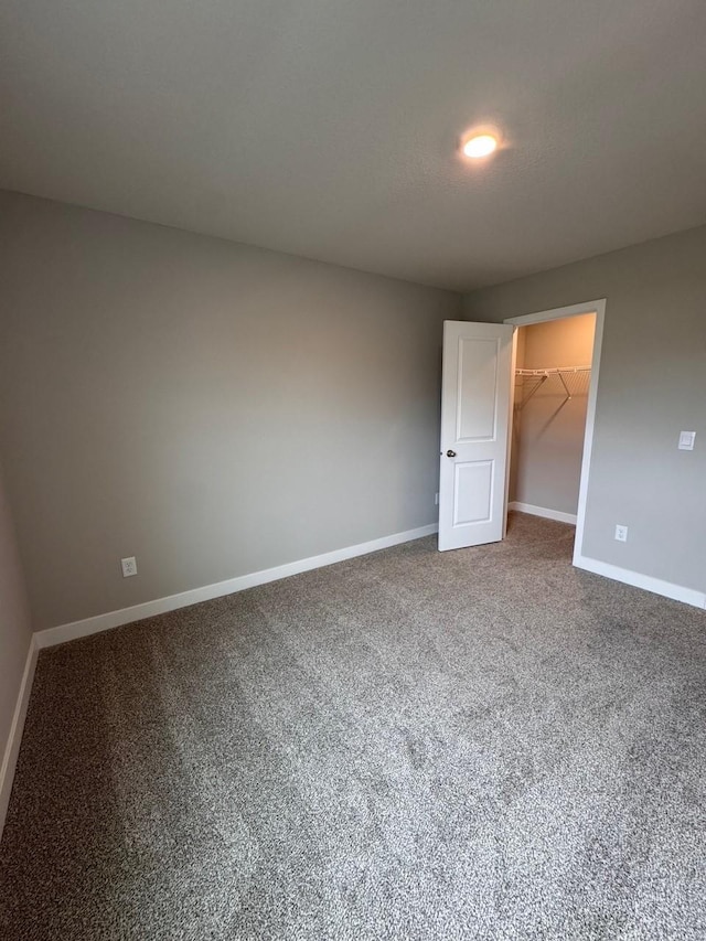 9829 89th St S, Cottage Grove, MN 55016 - unfurnished bedroom with a spacious closet, baseboards, and carpet floors
