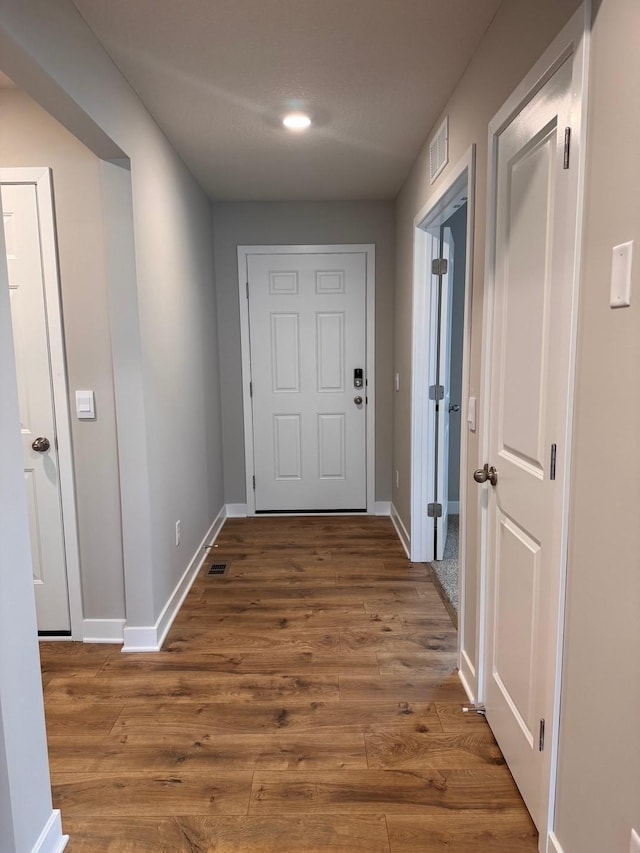 9829 89th St S, Cottage Grove, MN 55016 - hallway featuring baseboards, wood finished floors, and recessed lighting