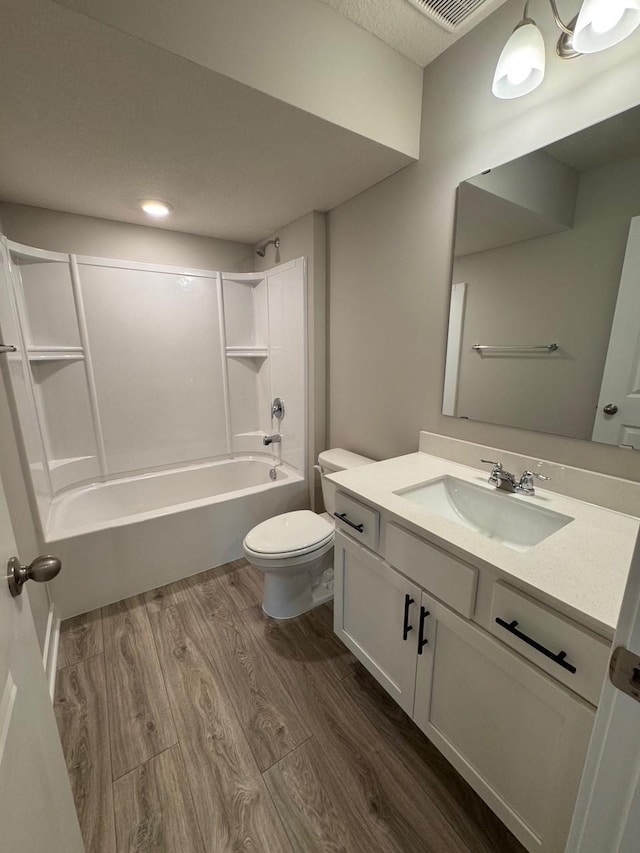 9829 89th St S, Cottage Grove, MN 55016 - bathroom featuring wood finished floors, shower / bathtub combination, toilet, and vanity