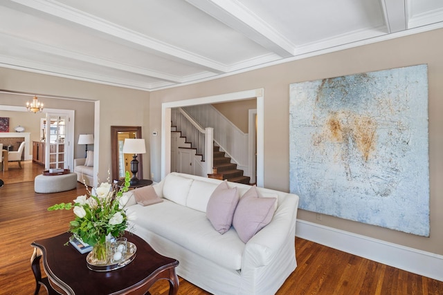 living area featuring ornamental molding, wood finished floors, beamed ceiling, stairway, and a notable chandelier