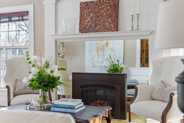 sitting room with a healthy amount of sunlight and a glass covered fireplace