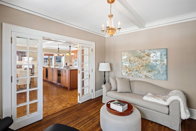 living room featuring an inviting chandelier, french doors, baseboards, parquet flooring, and ornamental molding