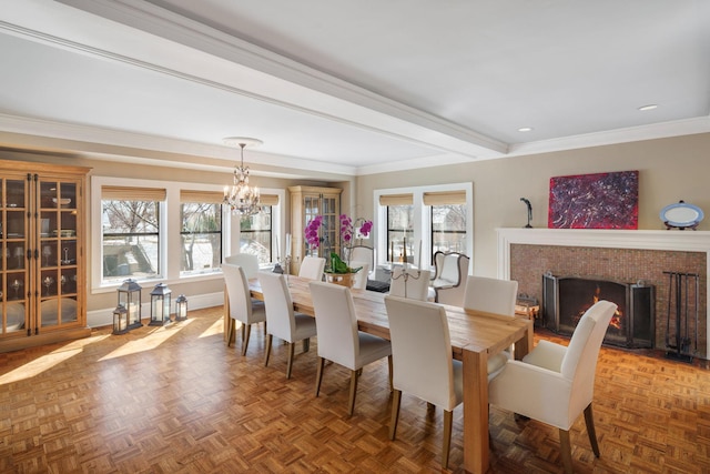 dining area with ornamental molding, baseboards, recessed lighting, a fireplace with flush hearth, and a notable chandelier