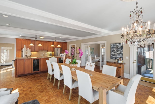 dining room with crown molding, an inviting chandelier, beam ceiling, baseboards, and beverage cooler