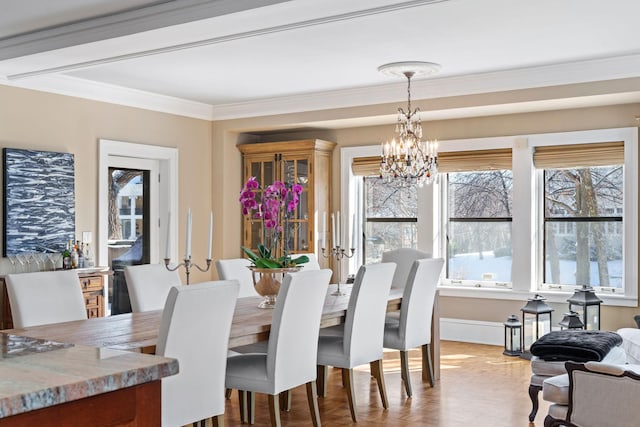 dining space featuring crown molding and a notable chandelier