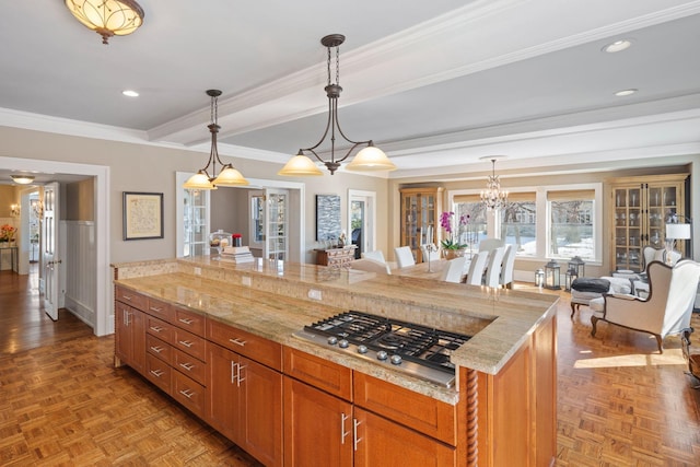 kitchen featuring crown molding, recessed lighting, light stone countertops, and stainless steel gas stovetop