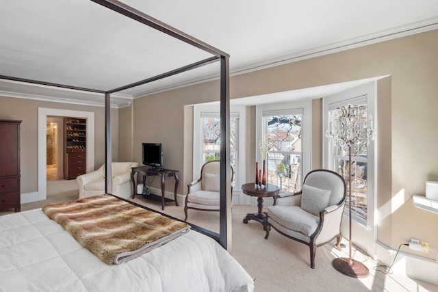 bedroom featuring light colored carpet, ornamental molding, baseboards, and a closet