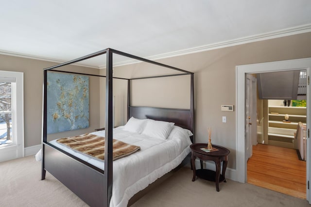 bedroom featuring baseboards, ornamental molding, and light carpet