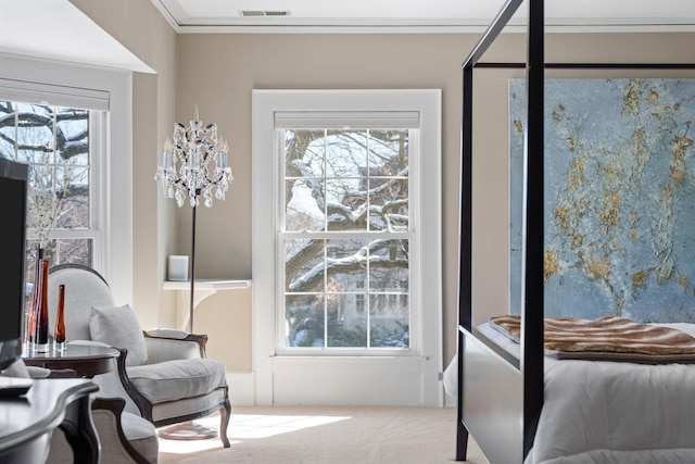 interior space featuring visible vents, crown molding, and multiple windows