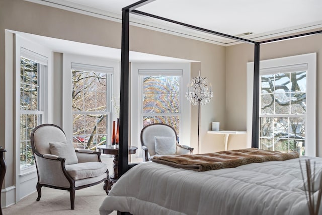bedroom featuring carpet floors, ornamental molding, and multiple windows