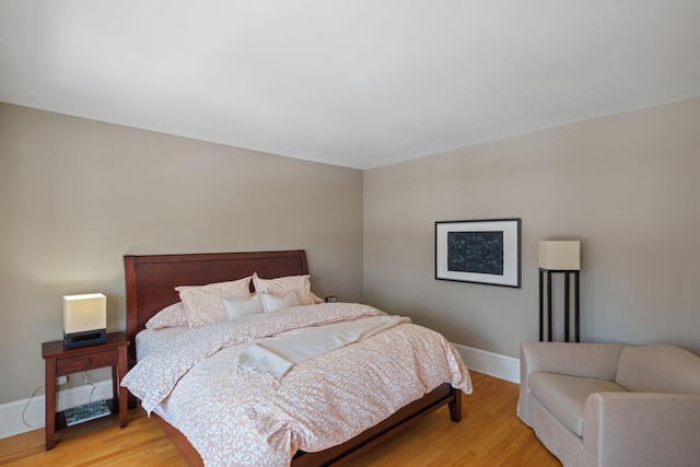bedroom featuring baseboards and light wood-type flooring