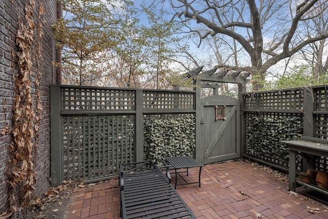 view of patio / terrace with a gate, fence, and a pergola