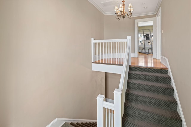 staircase featuring crown molding, baseboards, and a notable chandelier