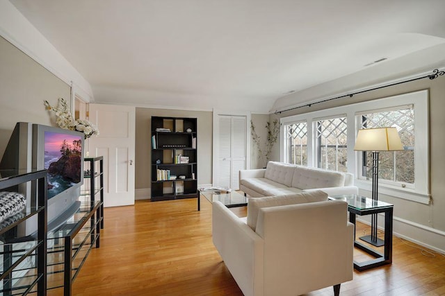 living area with light wood-style floors and baseboards