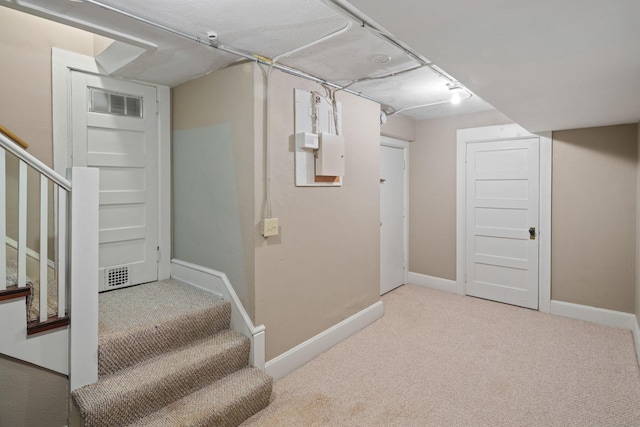 finished below grade area with stairs, baseboards, and carpet floors