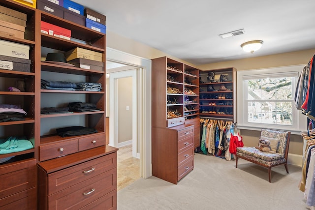 walk in closet featuring light colored carpet and visible vents