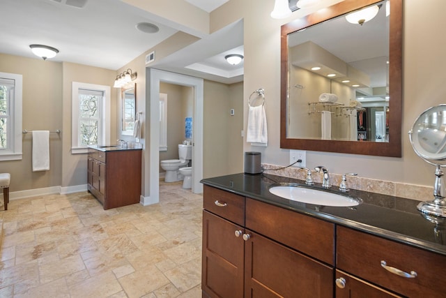 full bath featuring baseboards, visible vents, a bidet, and a sink