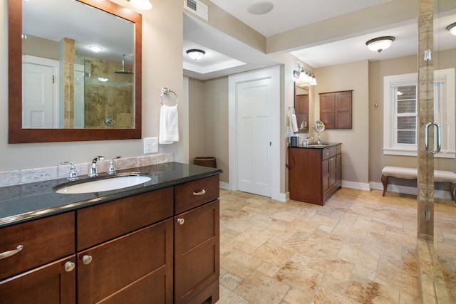 full bathroom with a sink, baseboards, a stall shower, and visible vents
