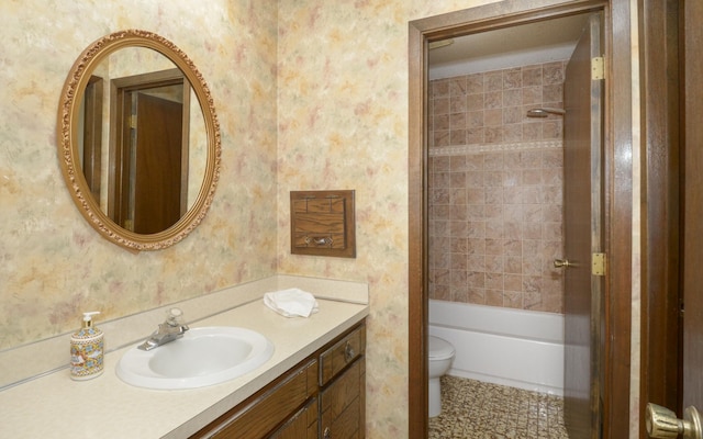 9805 Jackson St NE, Blaine, MN 55434 - bathroom featuring vanity, wallpapered walls, toilet, and shower / bathtub combination