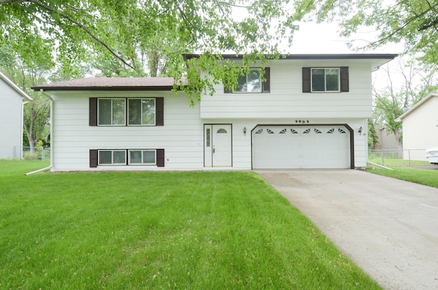 9805 Jackson St NE, Blaine, MN 55434 - tri-level home featuring a garage and concrete driveway