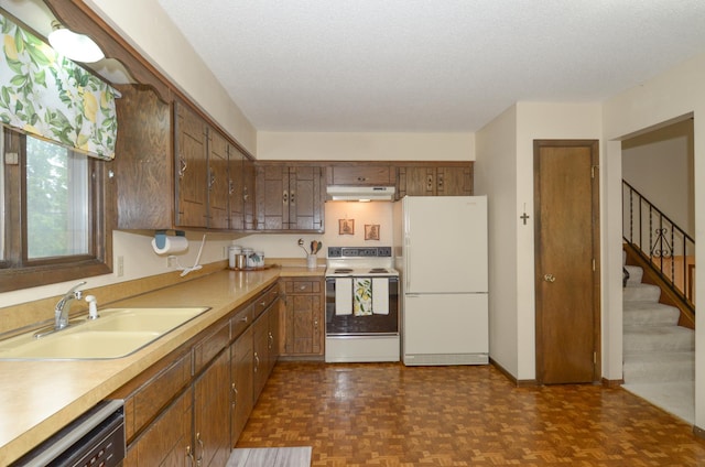 9805 Jackson St NE, Blaine, MN 55434 - kitchen with white appliances, under cabinet range hood, a sink, light countertops, and a textured ceiling
