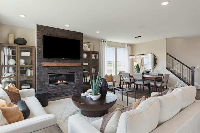 living area featuring a fireplace, stairs, recessed lighting, and baseboards