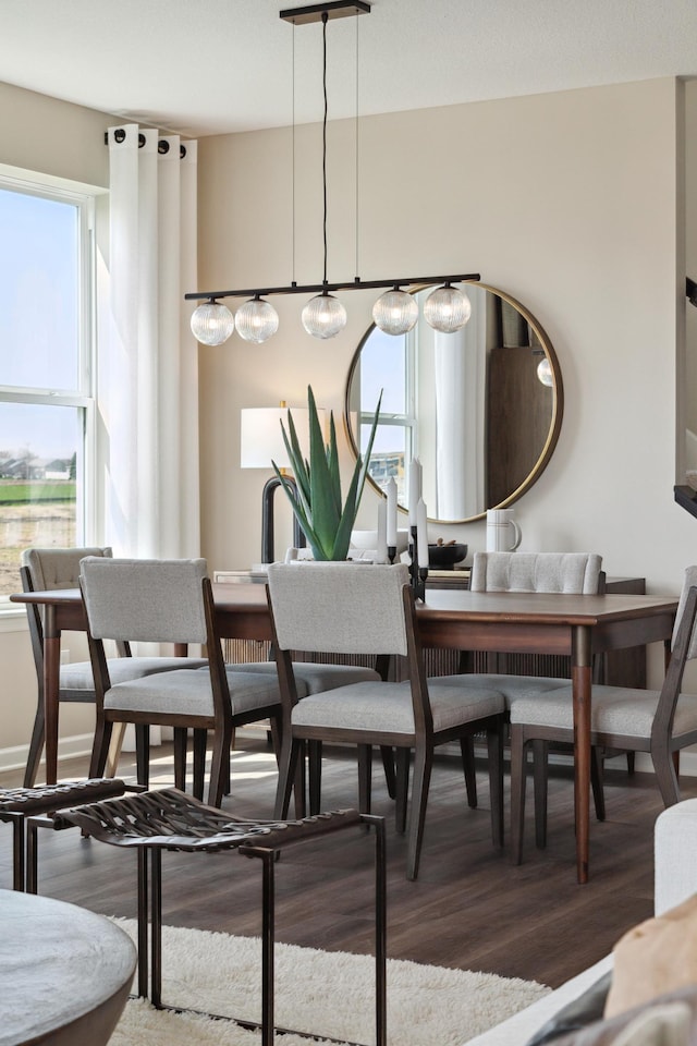 dining area with wood finished floors and plenty of natural light