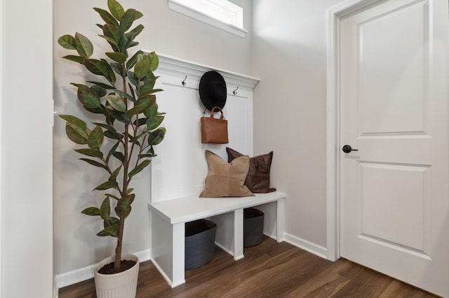 mudroom with dark wood-style floors and baseboards