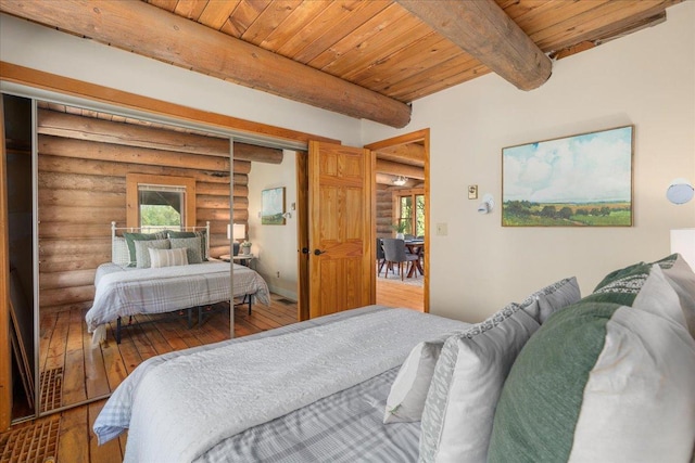 1100 155th St, Garfield Twp, WI 54001 - bedroom featuring log walls, wood-type flooring, beam ceiling, and wooden ceiling