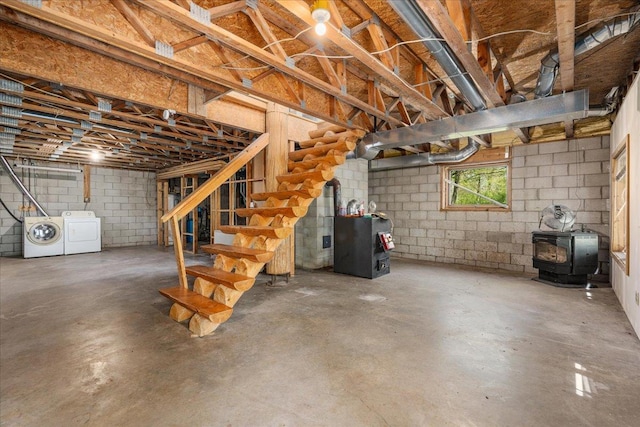 1100 155th St, Garfield Twp, WI 54001 - below grade area with separate washer and dryer, a wood stove, stairs, and concrete block wall