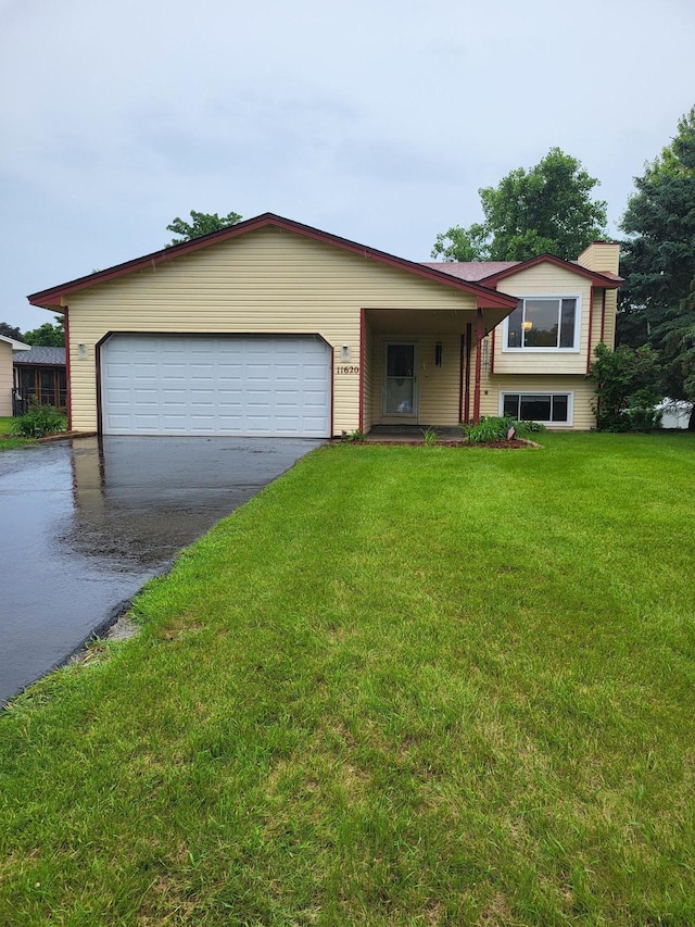 11620 Oregon Ave N, Champlin, MN 55316 - split level home with concrete driveway, a front lawn, and a garage