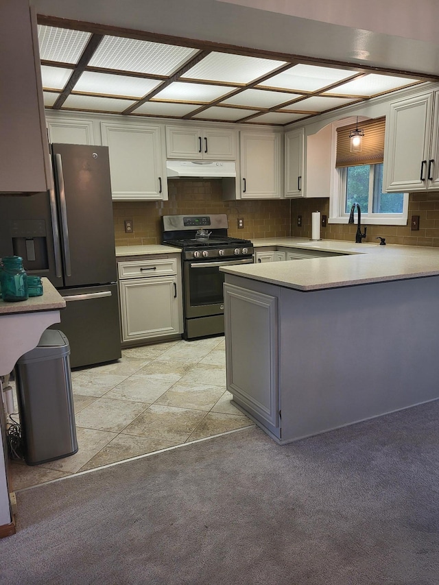 11620 Oregon Ave N, Champlin, MN 55316 - kitchen with stainless steel appliances, under cabinet range hood, a peninsula, light countertops, and tasteful backsplash