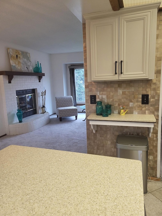 11620 Oregon Ave N, Champlin, MN 55316 - kitchen with a fireplace, light countertops, open floor plan, carpet, and white cabinets