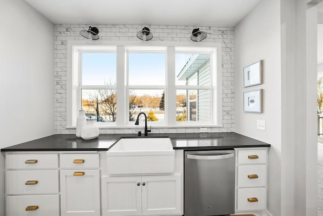 kitchen featuring a sink, dark countertops, and a wealth of natural light