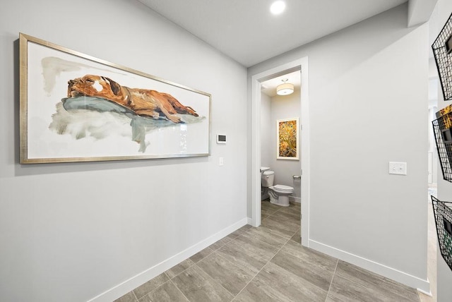 hallway featuring baseboards