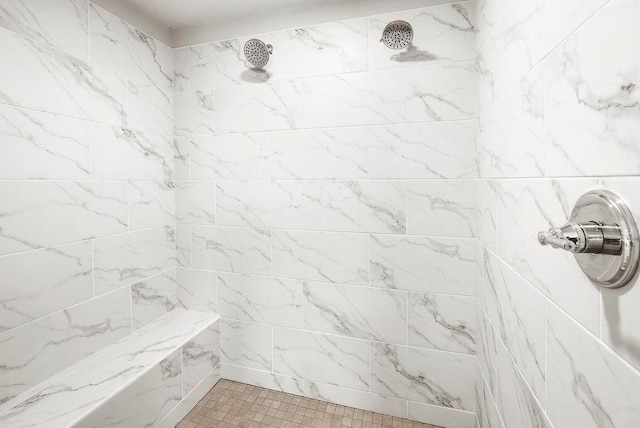 full bath with a tile shower