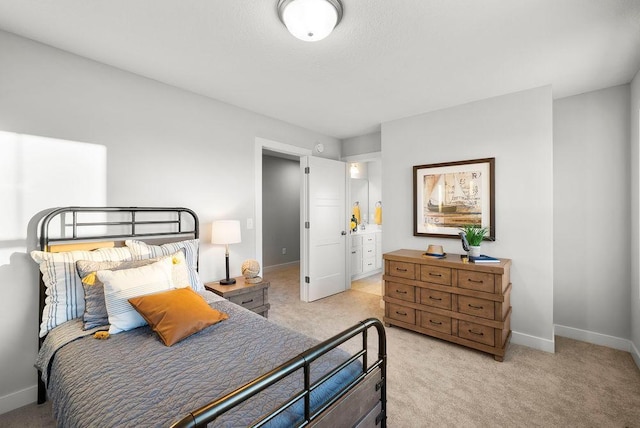 bedroom with baseboards and light colored carpet
