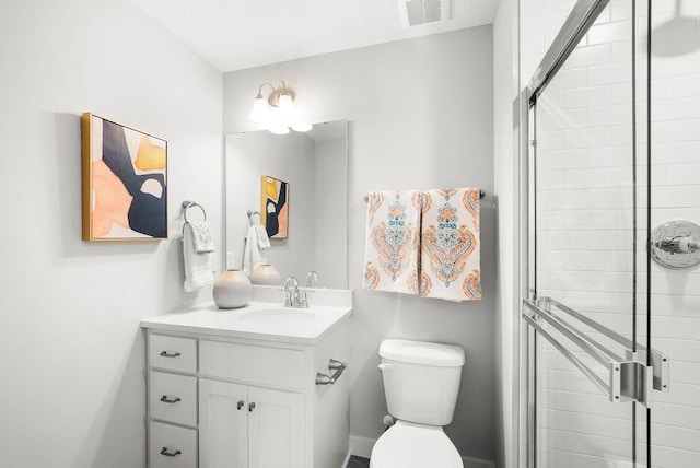 bathroom with a shower stall, visible vents, toilet, and vanity